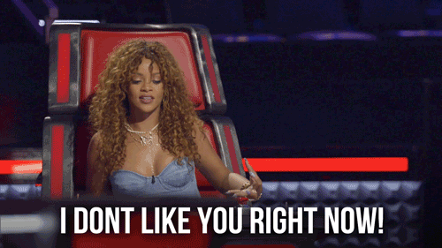 Photo of Rihanna sitting in judge chair on The Voice with text overlay "I DON'T LIKE YOU RIGHT NOW!"